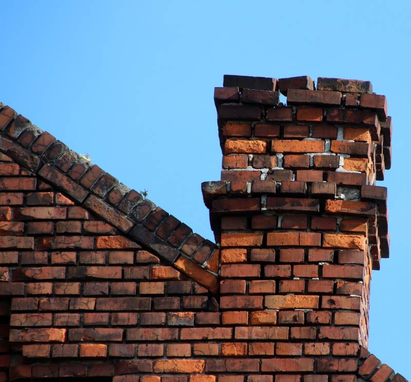 Signs Your Bladensburg Home Needs a Chimney Inspection Damaged chimney on an Bladensburg home showing cracks and missing mortar